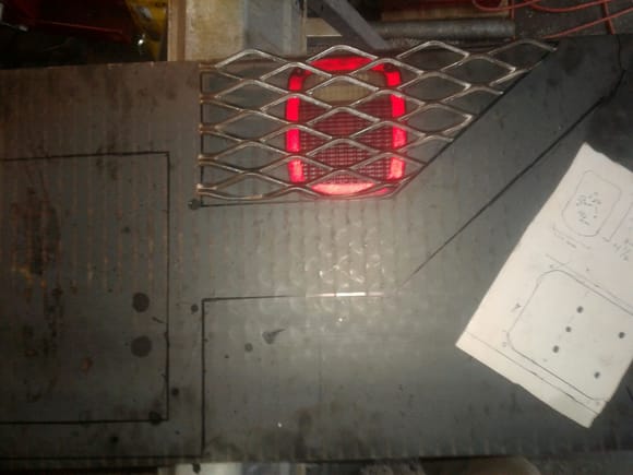 Plate in background stenciled for cut. Screen and taillight (lens) in place.