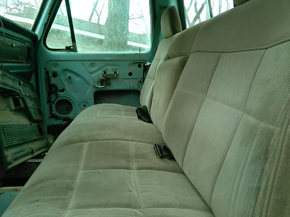 Brown seat from a 90s model truck with the fold down center console.  $30 find. Still need a 70s frame to get it installed.