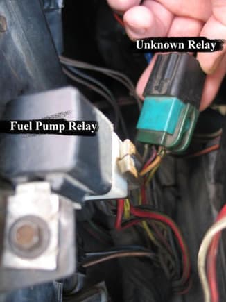 Two Relays. 
E in the first Part Number series = 1980's
FUEL=GREEN BASE
EEC=BROWN BASE
I think the 'unknown' image on right with dark green relay is the FUEL. The other might be the EEC relay.

I think the black and white attached (left pic) to the metal tab of sidewall, has the OEM Dark Brown base relay. (EEC)

The pic on right might (green) be the FUEL relay.
 would be the fuel pump relay. I have a part number off an old relay# 1CCE8DB13853-AA, which was replaced by F8PZ14N135-EA, if correct.

 I also found these numbers...Green base - E3TB9345-AZA, and grey base - E4LB 13A025-AZA

Both have four metal tab contacts in each one. Three spades running one way, and one facing them in another direction.
They might also be called multi-function switches.