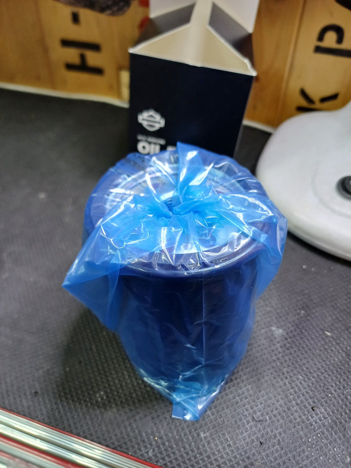 Filter wrapped in plastic bag.