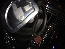 I had drilled a 3/8 hole at 5 o'clock and pressed in the breather nipple so the breather sits flush on the air box. The clamped hose hold the breather element firmly in place.