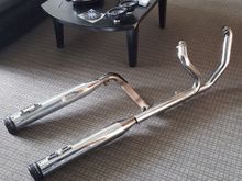 Came off 2011 ultra.  They fit 2009-2016 touring. No bluing. No dents. Small scrape on bottom of end cap, not visible unless you turn the muffler over. $300 plus shipping from Detroit and they come with the stock head pipe with the cat removed already. Cuts down DRASTICALLY on the heat. A little dirty in the pics, but i wil clean them up before i ship them.