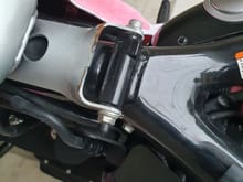 Remove the screw under the seat holding the tank