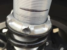 The spring pre-load collar is split and pin tool holes distorted by extorting extreme force on the pin tool.