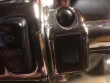 Here’s my garage door opener. Chrome and sits just inside the left side controls. Worked like a charm for the last 3 years....