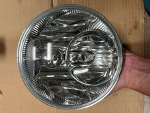 The white reflections are just ceiling lighting. The headlight is in very good condition 