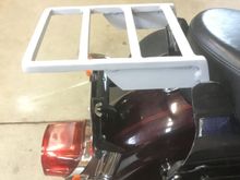 Mock mounted in the brackets.  Its fully in position, in them, just no screws in it.  The legs are drilled and tapped to 1/4-20 threads, the same as the sissy bar.
Hard to tell in this pic, but the flat top of the rack, is at the same angle as the top of the saddle bags.
I put the side braces on because I am thinking of building my own trunk for it and covering it in fake leather, like the saddlebags.  I cannot find one large enough for 2 FF helmets, at least that I can afford.
