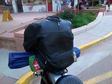 Under the leather was a regular old backpack. Medium height quick detach standard sissy bar with a motherwell luggage rack on the fender. Got creative with bungee cords and was able to carry a tent, sleeping bag, lawn chair, 3 days worth of clothes, hygiene supplies, 1 extra pair of shoes, chaps and my jacket. Took this setup on 2 trips to the tune of about 2k miles total.