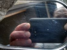 Had to take a few pics before I got the right angle to show the scratches and pitting in the mirror
