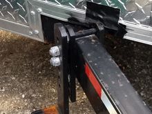 Here you can mostly see where I had to cut into the trailer body to get the weight distribution / sway control bar mounts on the frame.  The distance to the ball center was a minimum of 27" and I only had 25.5.  Only a small part of the body support frame (NOT the structural frame) and I filled that with some JB Weld.  The duct tape was a temporary thing until I could make a better seal.
