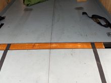 Threshold filler with anti-slip stuff from outside.  Rear tie-downs (factory)