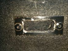 metal rectangle built into seat for seat tab. Jagged amateur cut, hole was also crooked on the seat.