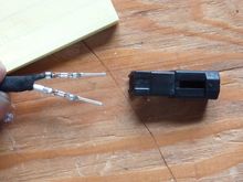 While pressing on the pin release tabs gently pull the wires one at a time out of the plug.