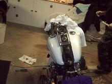 Slide tank back and old bars off. Job is alot more fun when you have pal to help. No that is not me in the pic.