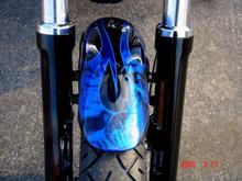 FRONT FENDER PAINT
Airea 5150 - Painter
Black Base with Dark Blue Ghost Flame
Silver Metal-Flake Tribal Flame w/ Air-Brushed Skulls
Cobalt Blue Candy over Tribal Flames then Pinstriped
Several Coats of High Gloss Clear Coat
Modified for 21" Wheel (vs 19" stock)