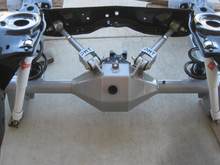 black powdered frame, silver control arms (adj.), silver Alston chassisworks fab9 housing strange nodular 3rd member with strange 31 spline axles.