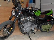 2009 1200N, Black Bullet style Headlight, flat black heat shields and A/C, flipped mirrors, relocated turn signals w/ smoked lenses, drilled stock baffles