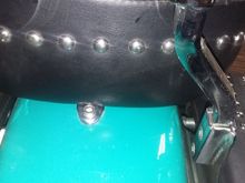 Passenger seat bolted through tab and fender.