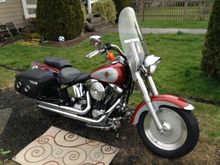 New to me, 1999 Evo Fat Boy. Her name is Ginger. Today I added Road King Hard Leather bags, bag brackets, an LED Tombstone tail light and Screamin' Eagle pipes.