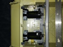 Motors sitting in mounts close up , ruler for scale. 