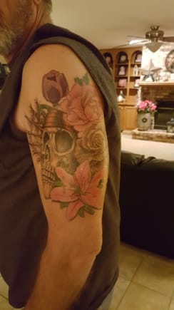 This one started as a memorial to my oldest daughter who has passed. After contemplating it for a while,  I decided to include all 4 of my children in it. Each of the 4 flowers represent my children, they are individually their favorite flower. The skull is....... well a skull and the web is indicative of the tangled web of a life I've lived. 