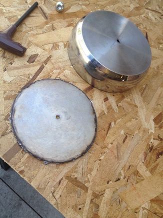 I picked up a couple of stainless sauce pans from the local Goodwill.  One for the main body and another to build the medallion.  I cut both pieces with a plasma cutter.  I had a jig in the center hole with an arm to hold the plasma cutter to make a circle.  The main part of the air cleaner needed to be cut shorter to clear the backing plate.