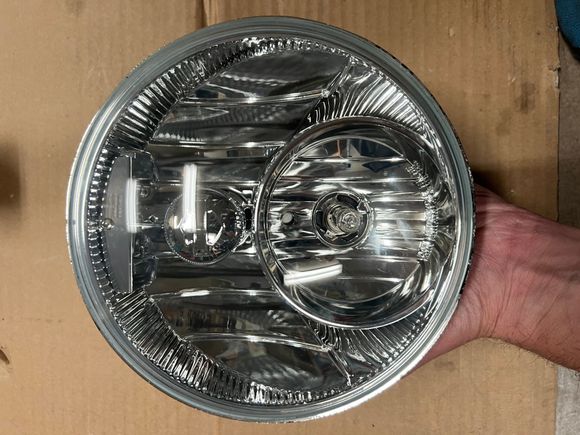 The white reflections are just ceiling lighting. The headlight is in very good condition 