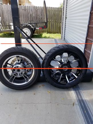 Obviously no exact number for difference but here is a little line showing the stock 16 next to an 18 with a 180/55/18 tire. 