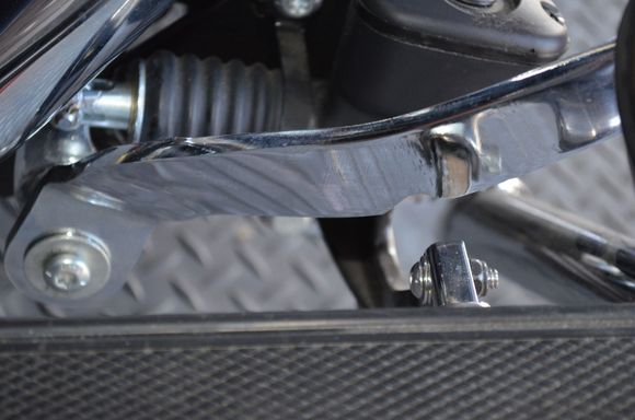 slight wrinkle in the chrome and the notch to clear pedal extension.