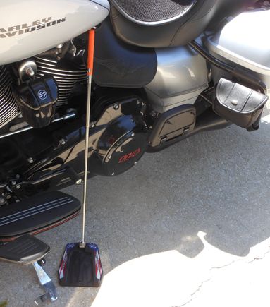 I carry my kick stand puck, that I picked up at the vendors during Bike Week,  in the left side pouch that hangs on the saddlebag guard.  I can reach it while sitting on the bike.  The colaspable stick has a mgnet on the bottom that lets position it and pick it up while sitting on the bike.  Works good. I guess it is worth the $20 I paid for it.