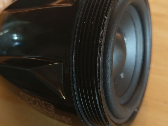 Having the darndest time removing this pyle bullet speaker from its housing. I realize I could just stick a screwdriver through it and probably get it off but I figure if I don't like the look ( I am putting horns in it)  I could always put the speaker back and use it on my bicycle.  Any ideas?  Glued on...