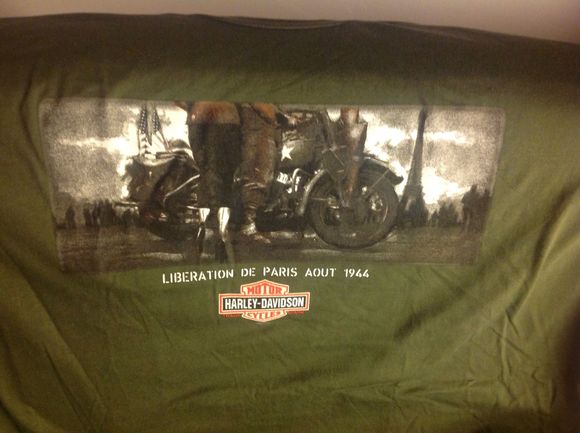 The front showing a set of pretty French legs, the Eiffel Tower in the background with a GI on  Hog.