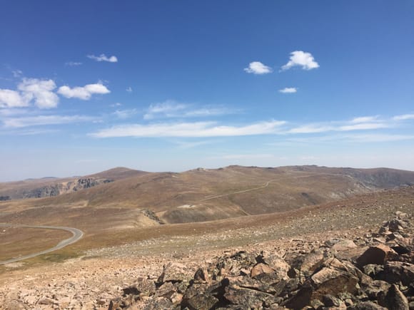 The top of the pass says 10,945 ft. But I wanted more, so I got a bottle of water and slowly started walking up towards the ridge on the south side of the road. This is as high as I got.