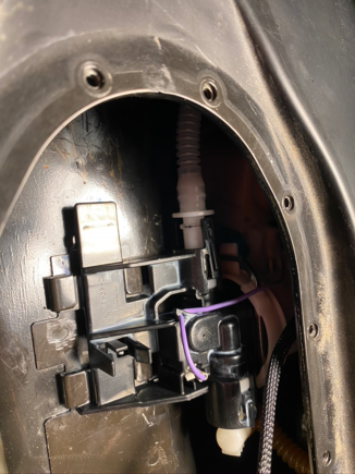 Dont follow steps in the manual...frustrating; pull up tab on the left, slide assembly forward a bit and gently lift then you can get both fingers on checkvalve line quick release