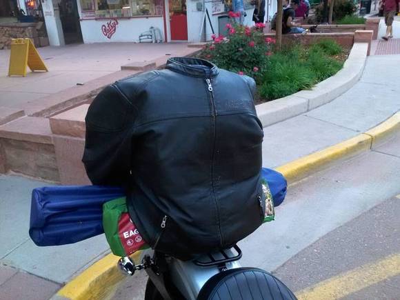 Under the leather was a regular old backpack. Medium height quick detach standard sissy bar with a motherwell luggage rack on the fender. Got creative with bungee cords and was able to carry a tent, sleeping bag, lawn chair, 3 days worth of clothes, hygiene supplies, 1 extra pair of shoes, chaps and my jacket. Took this setup on 2 trips to the tune of about 2k miles total.