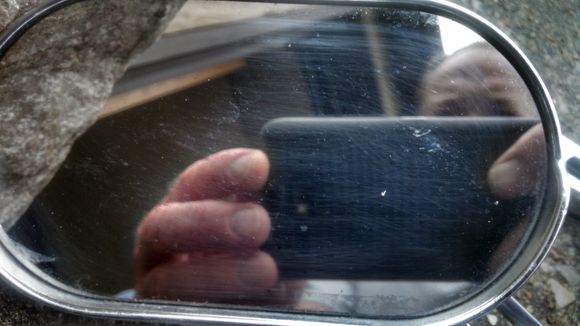 Had to take a few pics before I got the right angle to show the scratches and pitting in the mirror