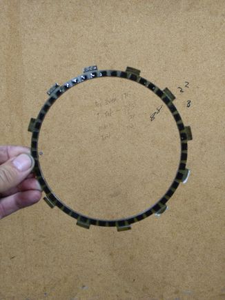 first plate, narrower than the other 8 because it houses an anti rattle spring for the entire clutch pack. The other 8 friction disks have 2x the amount of fiber..