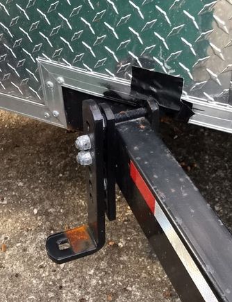 Here you can mostly see where I had to cut into the trailer body to get the weight distribution / sway control bar mounts on the frame.  The distance to the ball center was a minimum of 27" and I only had 25.5.  Only a small part of the body support frame (NOT the structural frame) and I filled that with some JB Weld.  The duct tape was a temporary thing until I could make a better seal.
