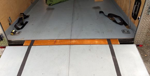 Threshold filler with anti-slip stuff from outside.  Rear tie-downs (factory)