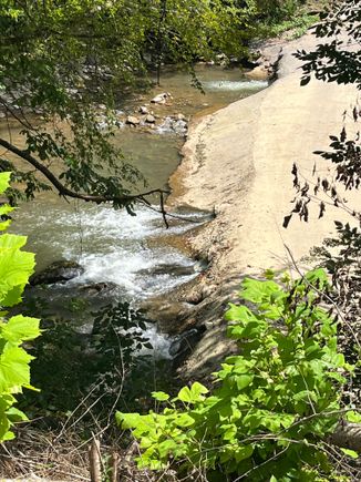 Crick behind the shop… a swinging bridge goes across 