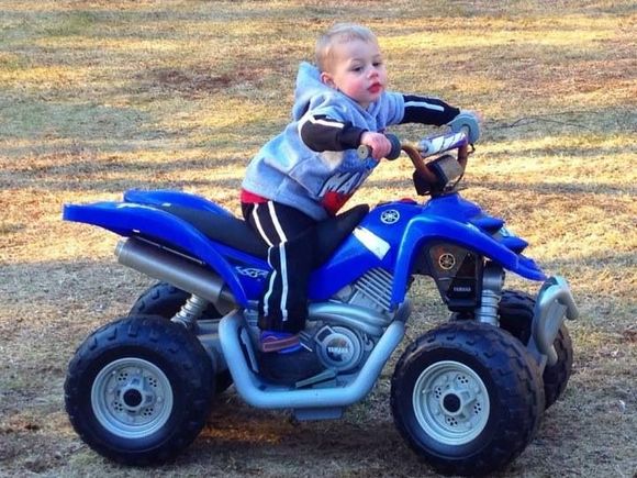 He loves his power wheel quad at tuna half years old