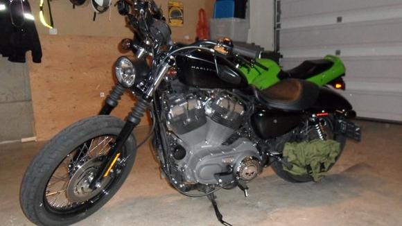 2009 1200N, Black Bullet style Headlight, flat black heat shields and A/C, flipped mirrors, relocated turn signals w/ smoked lenses, drilled stock baffles