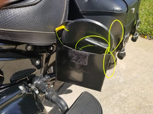 Cover closes with velcro so very easily reached while still straddleing the bike.  