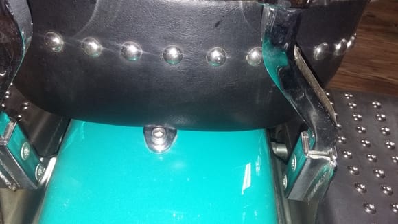 Passenger seat bolted through tab and fender.