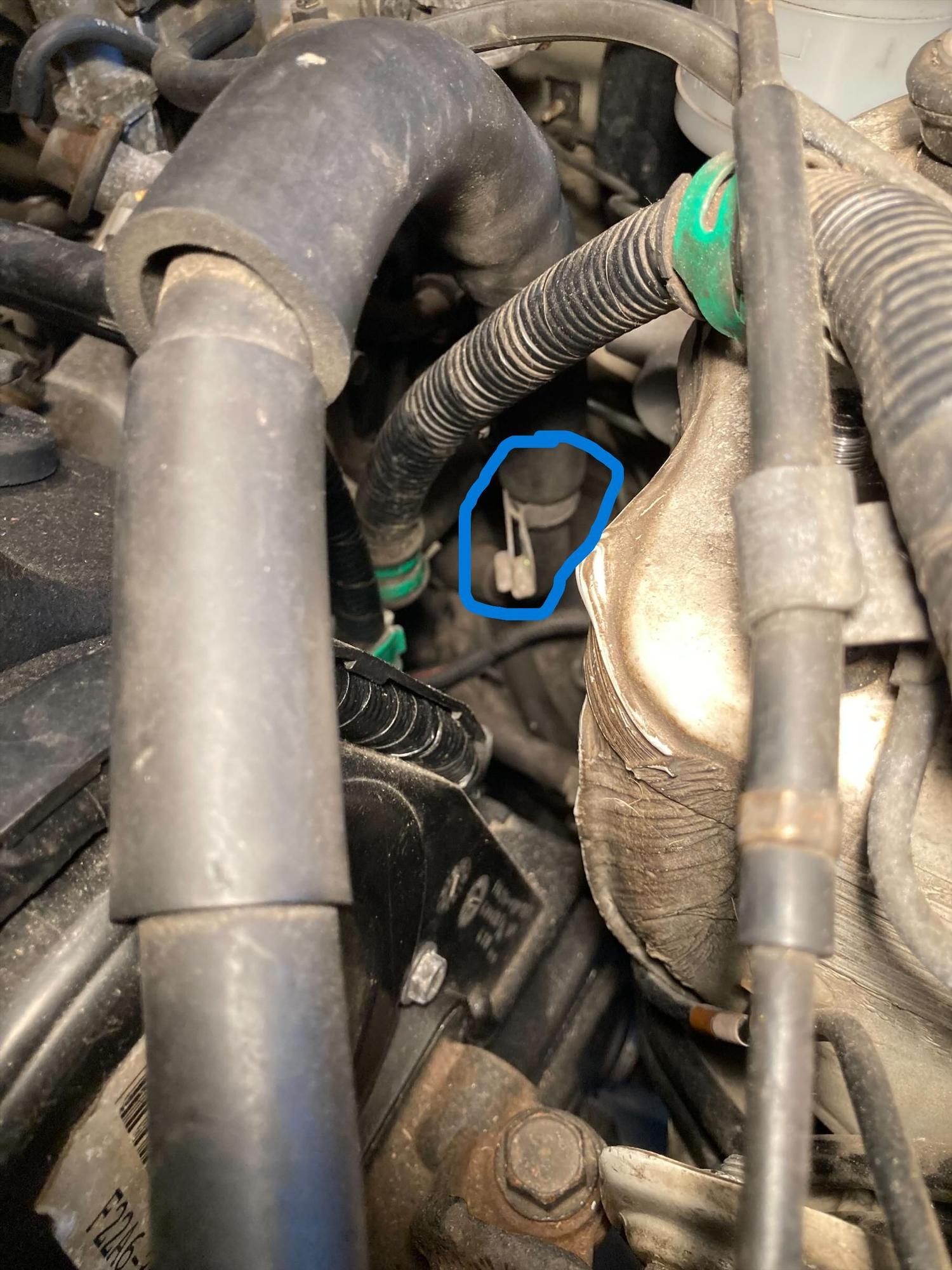 Hose from power steering pump in front of and below master cylinder