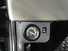 Guage ON/OFF Switch directly in front of the Parking Break. Takes time to adjust without kicking down the guage. Need muscle memory, it turned out to be a perfect spot.