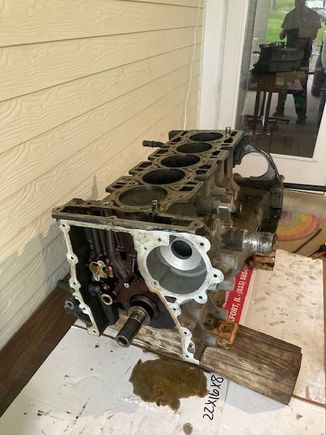 Engine on work bench; wood underneath ensures the weight of the block is not applying pressure on the crankshaft.  