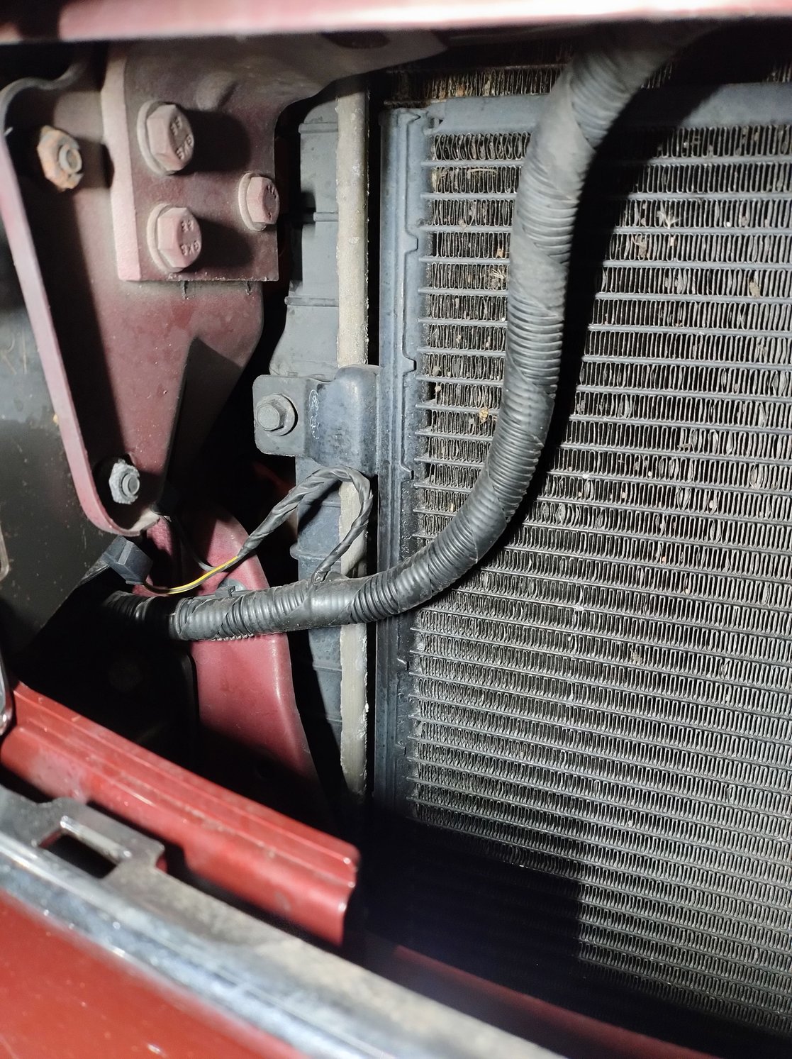 Bolt attaching the AC condenser to the radiator.