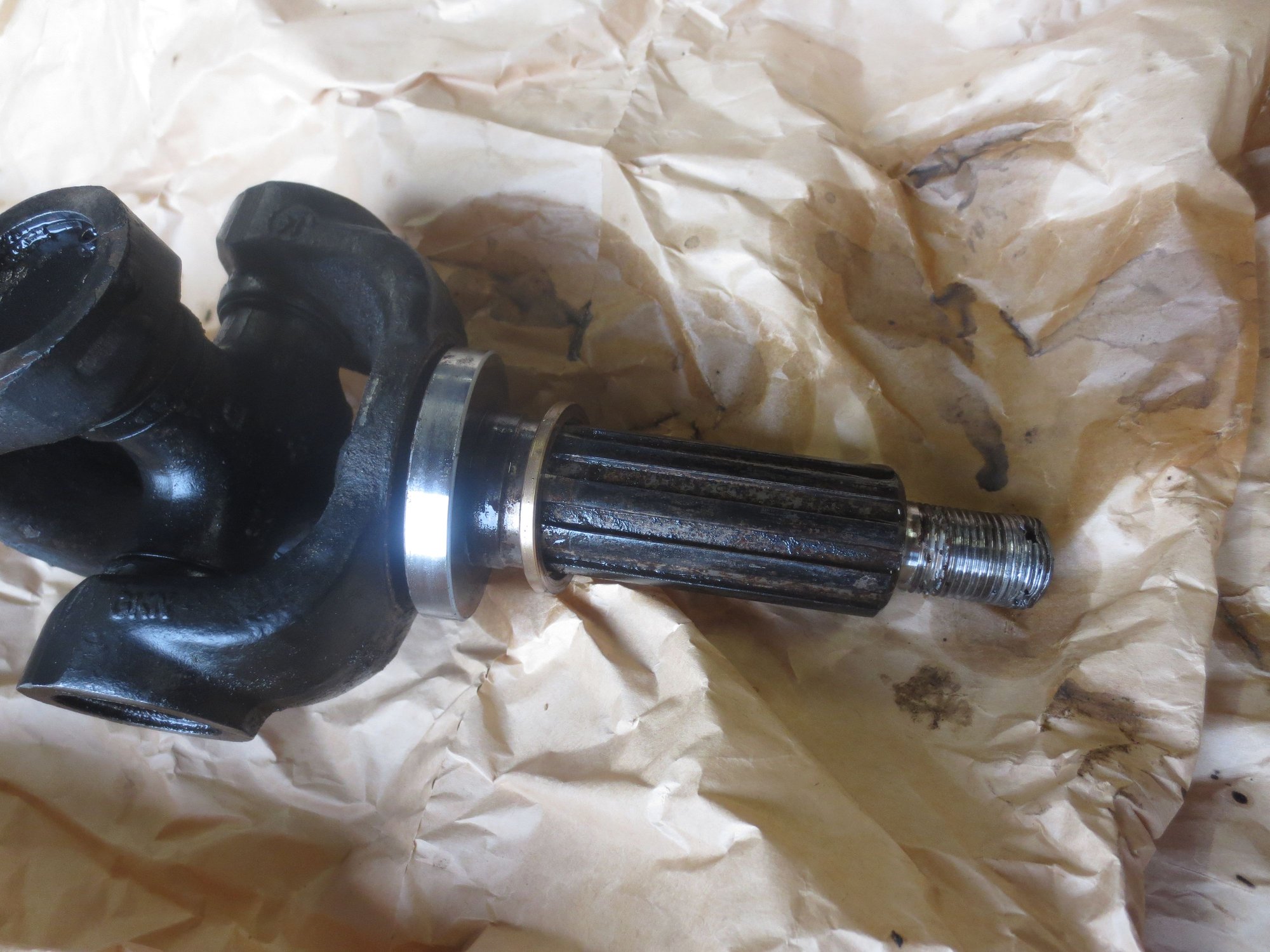 Oil seal track (large silver item, and endfloat spacer shim the brass-coloured item in the driveshaft, though it is not made of brass)