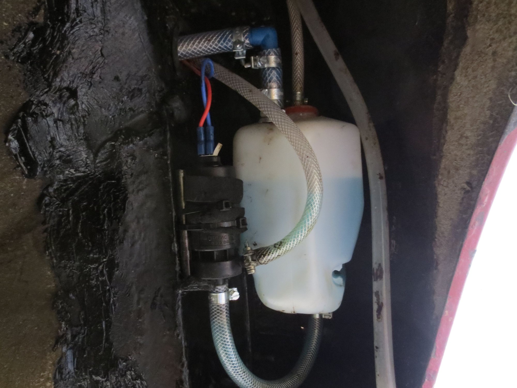 Washer reservoir in place with headlight  washer pump. The wing stoneguard covers this all up